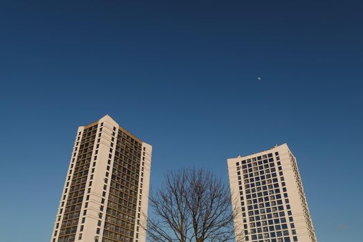 The urban landscape of large city. Exteriors of typical modern apartment buildings against a blue sky with clouds