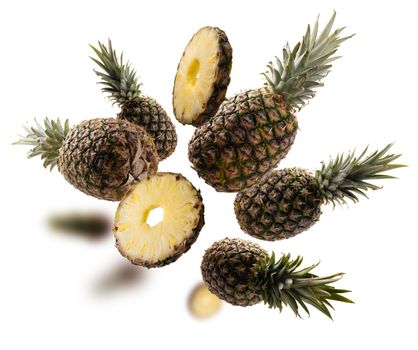 Ripe pineapples levitate on a white background.
