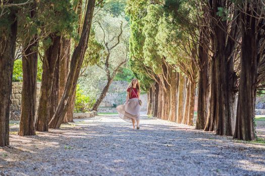 Woman tourist walking together in Montenegro. Panoramic summer landscape of the beautiful green Royal park Milocer on the shore of the the Adriatic Sea, Montenegro.