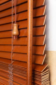 Wooden jalousie as a background. Wooden shutters on the window in the jalousie boutique.
