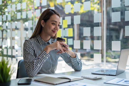 Portrait of beautiful Asian business woman with coffee at office