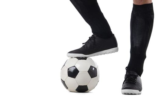 leg of soccer football player with ball isolated on white background