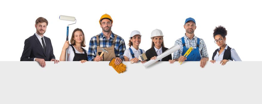 Portrait of happy construction workers holding blank billboard isolated on white background, empty copy spcae for text content