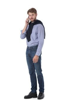 Full length portrait of handsome young business man in casual wear talking by cell phone isolated on white background, casual people