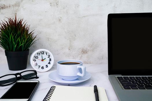 Styled stock photography white office desk table with blank notebook, computer, supplies and coffee cup. Copy space.