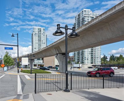 City plaza overview on a bright sunny day. Street view with skytrain line over head