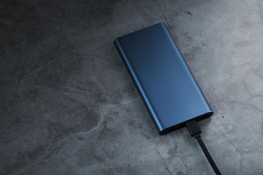 Battery Power supply for recharging gadgets and electronic devices on a dark background