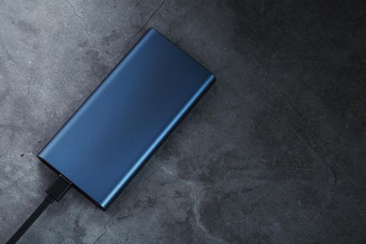 Battery Power supply for recharging gadgets and electronic devices on a dark background
