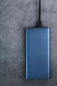 Battery Power supply for recharging gadgets and electronic devices on a dark background