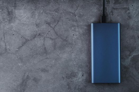Battery Power supply for recharging gadgets and electronic devices on a dark background