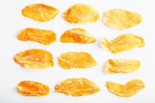 Organic dried mango fruit slices isolated on white background