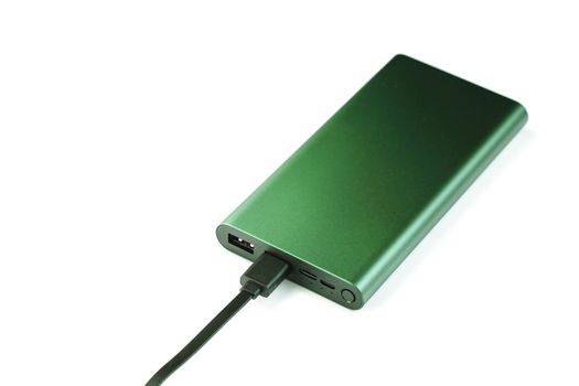 Green Power Bank on a white background for charging mobile devices with copy space.