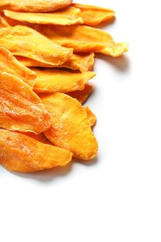 Ripe dried mango sliced on a white background with free space