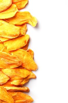 Ripe dried mango sliced on a white background with free space