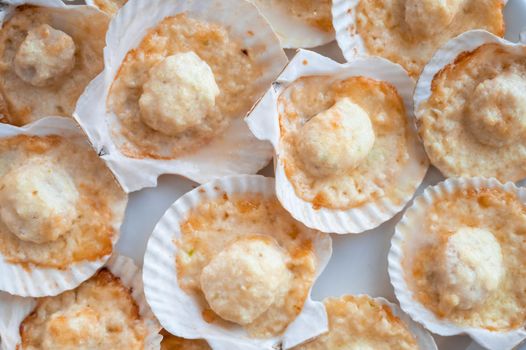 Plate with delicacy roasted scallops with cheese