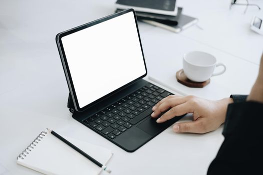 Young man using work from home tablet at work, the blank space on the computer screen can insert text