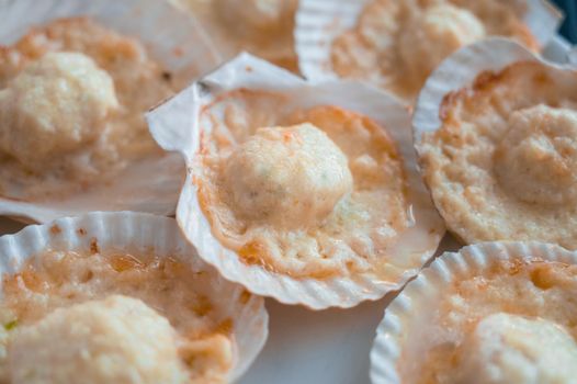 Plate with delicacy roasted scallops with cheese