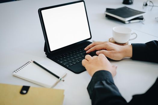 Young man using work from home tablet at work, the blank space on the computer screen can insert text