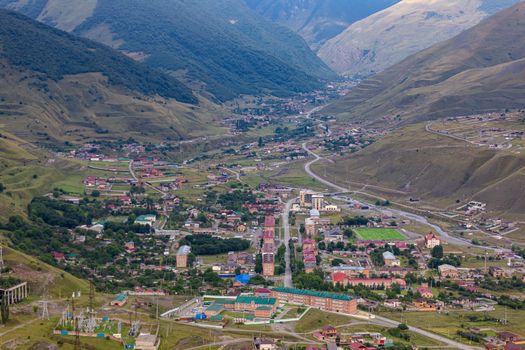Mountain landscape with a city at the bottom of the gorge. Upper Fiagdon in North Ossetia.