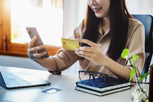 Online Shopping and Internet Payments, Beautiful Asian women are using their credit cards and mobile phones to shop online or conduct errands in the digital world