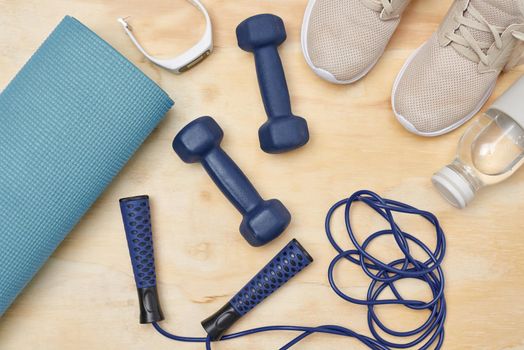Studio shot of a variety of workout equipment on a wooden floor.