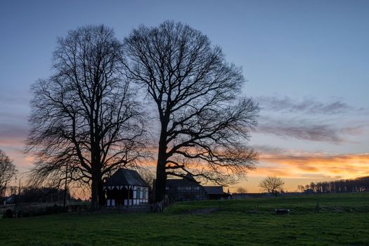 Panoramic image of small chapel under trees during sunrise, Bergisch Gladbach, Germany