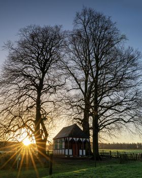 Panoramic image of small chapel under trees during sunrise, Bergisch Gladbach, Germany
