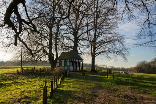 Panoramic image of small chapel under trees during sunrise, Bergisch Gladbach, Germany
