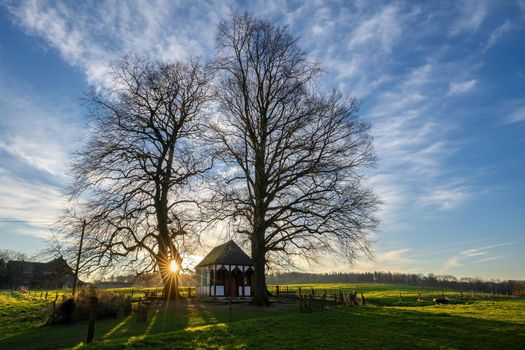 Panoramic image of small chapel under trees during sunrise, Bergisch Gladbach, Germany