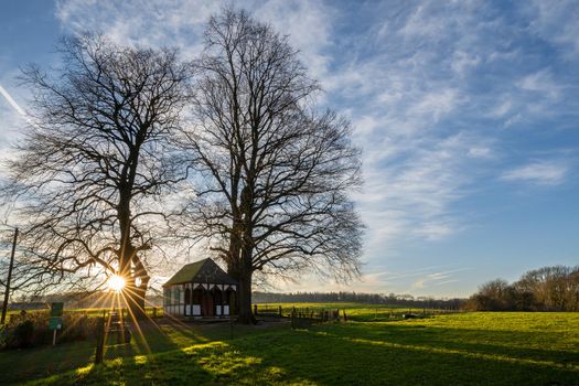 Panoramic image of small chapel under trees during sunrise, Bergisch Gladbach, Germany