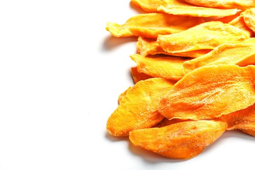 Ripe dried mango sliced on a white background with free space