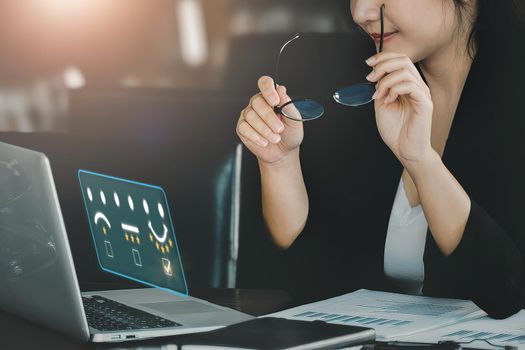 Quality and Satisfaction Rating Concept, Assessment, smiling businesswoman using laptop computer to answer surveys and assess 5-star satisfaction