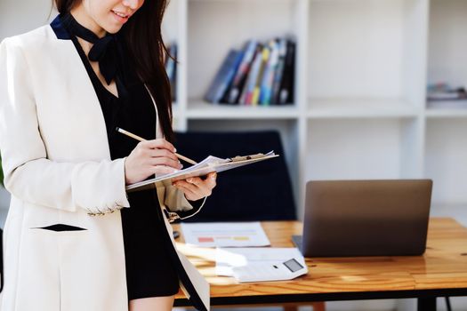 Young economists or accountants or financiers and investors are reviewing budget documents to study impact and risk assessments on corporate investment management