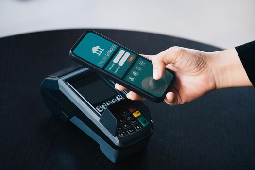 Secure payment technology concept and service charge, customers are using their phone to pay using paywave technology by tapping near the electronic card terminal