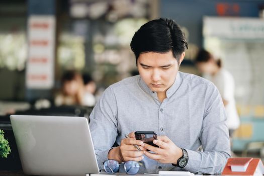 A male businessman is using the telephone to communicate with colleagues for financial planning and investment planning