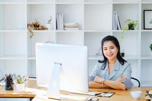 Young economists or accountants or financiers and investors are reviewing budget documents and using computers to study impact and risk assessments on corporate investment management