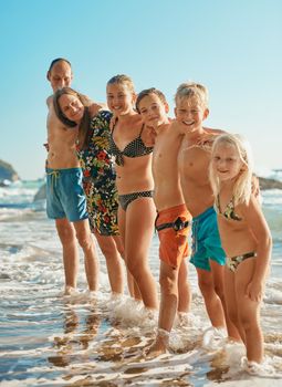 Shot of a family of six spending the day at the beach.