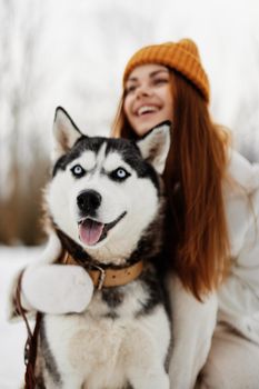 young woman with husky winter landscape walk friendship winter holidays. High quality photo