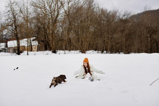 portrait of a woman in the snow playing with a dog fun friendship Lifestyle. High quality photo