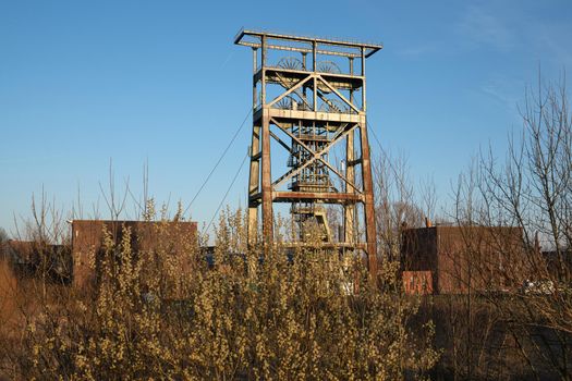 Headframe of old cold mine against sky, industrial heritage of Ruhr Metropolis, Dortmund, Germany