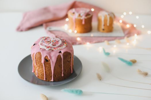 Easter cake, colorful eggs and willow branches on light background. Happy Easter holiday concept. festive spring season.