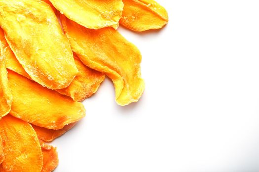 Ripe dried mango sliced on a white background with free space