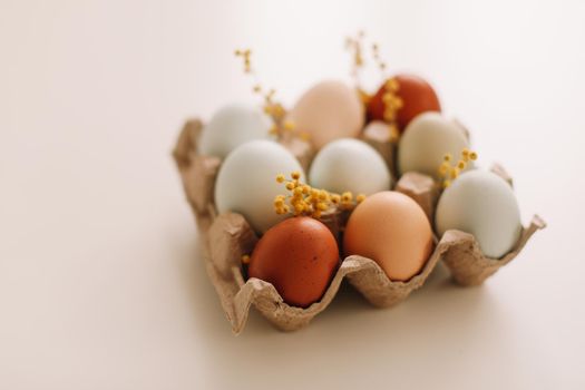 Chicken eggs of natural shades and colors on a white background. Healthy organic food, natural farmer's products concept. Happy Easter background. Selective focus. 