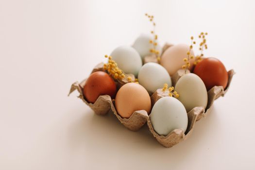 Chicken eggs of natural shades and colors on a white background. Healthy organic food, natural farmer's products concept. Happy Easter background. Selective focus. 
