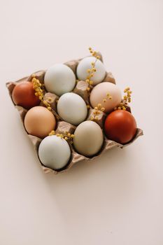 Chicken eggs of natural shades and colors on a white background. Healthy organic food, natural farmer's products concept. Happy Easter background. Selective focus. 