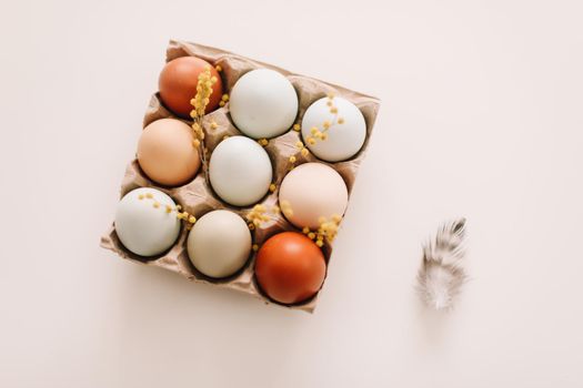 Chicken eggs of natural shades and colors on a white background. Healthy organic food, natural farmer's products concept. Happy Easter background. Selective focus. 