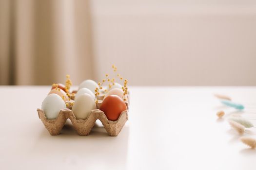 Chicken eggs of natural shades and colors on a white background. Healthy organic food, natural farmer's products concept. Happy Easter background. Selective focus. 