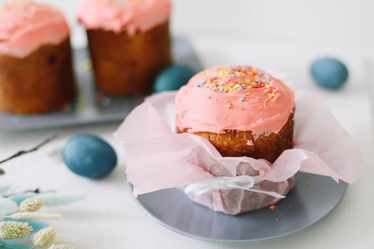 Easter cake, colorful eggs and willow branches on light background. Happy Easter holiday concept. festive spring season.