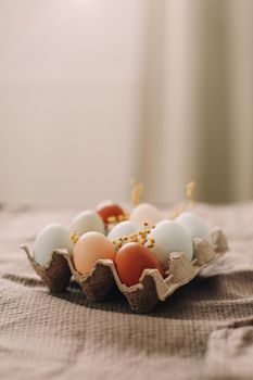 Chicken eggs of natural shades and colors on a white background. Healthy organic food, natural farmer's products concept. Happy Easter background. Selective focus. 