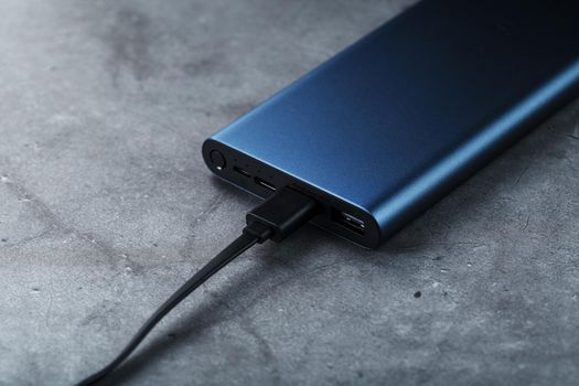 Battery Power supply for recharging gadgets and electronic devices on a dark background